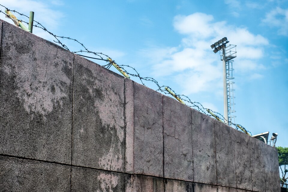wall-stone-with-coils-barbed-wire-security-camera-large